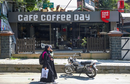 Srinagar-Cafe Coffee Day shop closed Women walk past a closed Cafe Coffee Day (CCD) outlet in Srinagar on July 31, 2019. CCD's owner VG Siddhartha committed suicide by jumping in the River Netravathi near Mangaluru. (Photo: PTI)